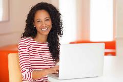 Woman smiling seated at desk