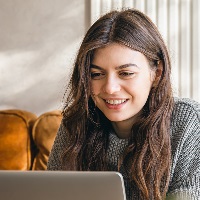 Woman typing on laptop at desk